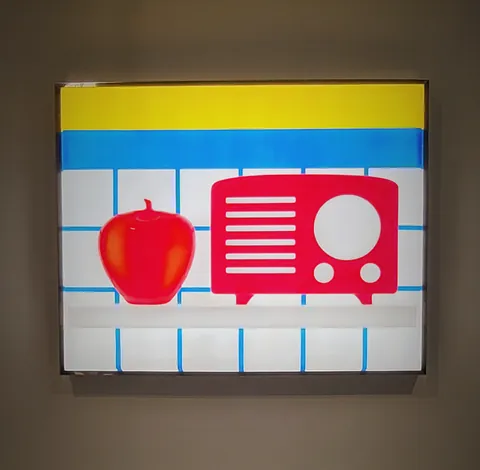 Une pomme et une radio rouges peintes sur un panneau lumineux
